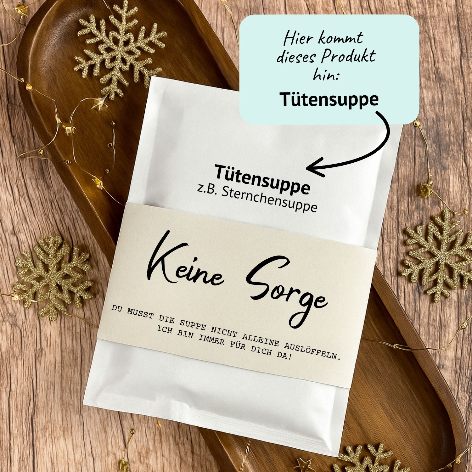 Tütensuppe Geschenkidee zum Ausdrucken – Druckvorlage „Keine Sorge“ DIY Druckvorlage für eine Tütensuppe mit der Aufschrift „Keine Sorge – du musst die Suppe nicht alleine auslöffeln“. Die Suppe steckt in einer liebevoll gestalteten Banderole, umgeben von Holzdeko und goldenen Schneeflocken. Humorvolle Geschenkidee zum Ausdrucken.